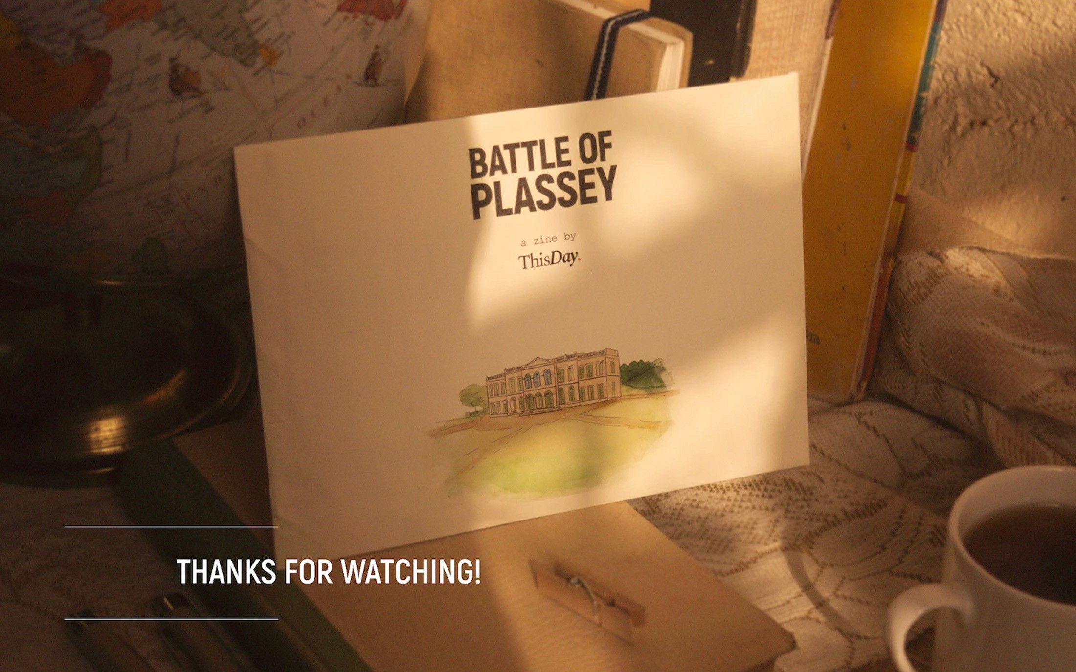 Battle of Plassey zine propped against books on a table, with the words Thanks for Watching