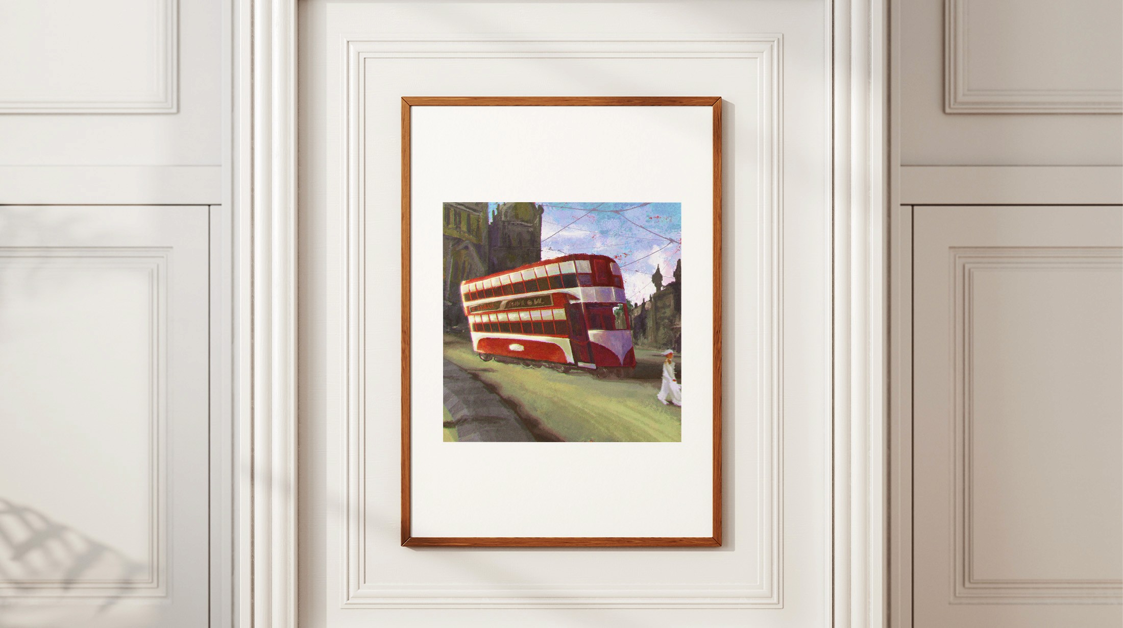 Framed print of the Bombay BEST tram illustration hanging on a white panelled wall