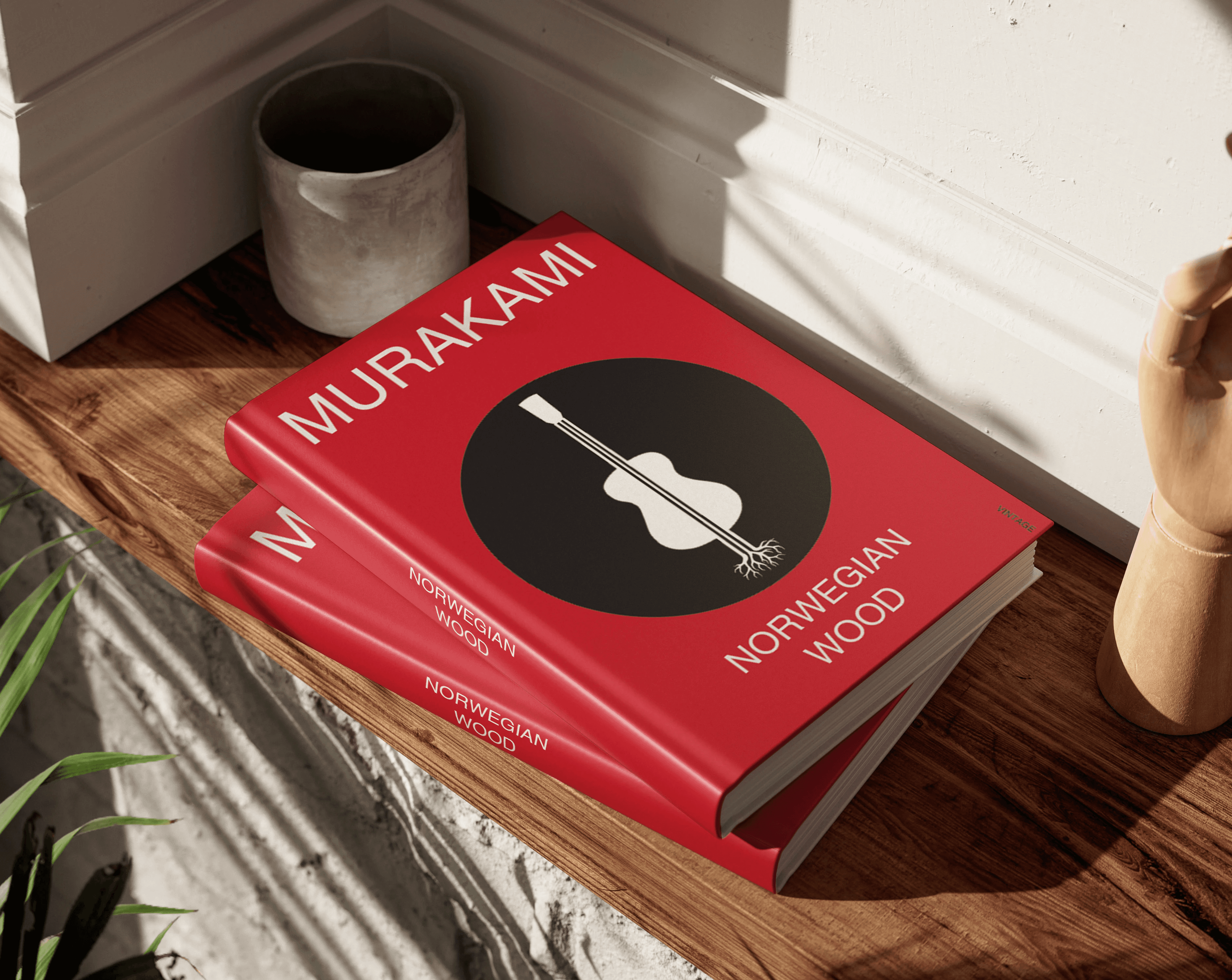 Book cover design for Haruki Murakami's Norwegian Wood: a red hardcover with a guitar in a black circle, styled on a windowsill