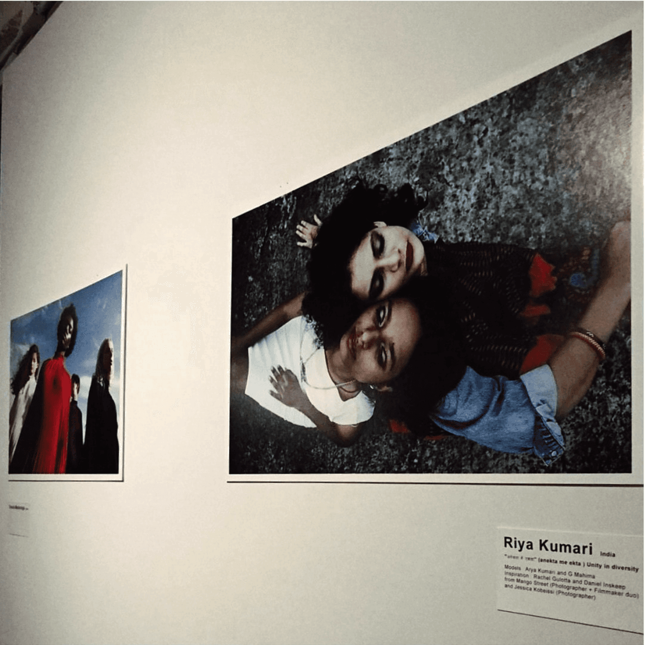Riya Kumari's photographs on display at an exhibition, including a large print of two friends lying on the ground