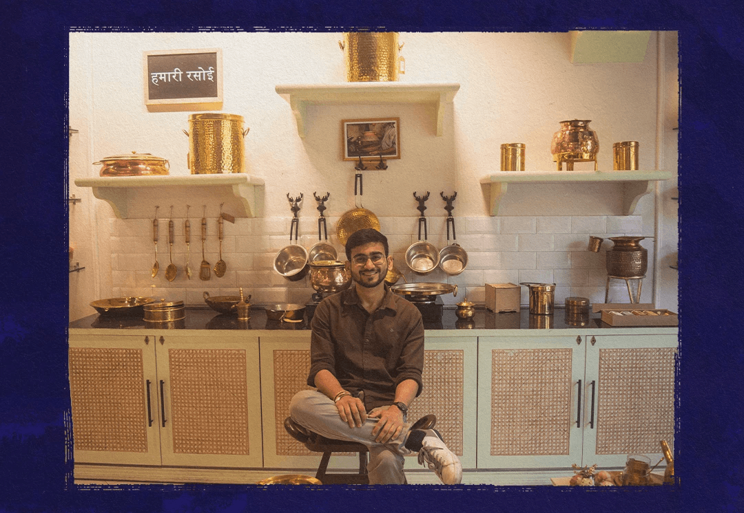 Aditya Agrawal, founder of P-Tal, sitting in a kitchen lined with brass and copper utensils, from a ThisDay interview