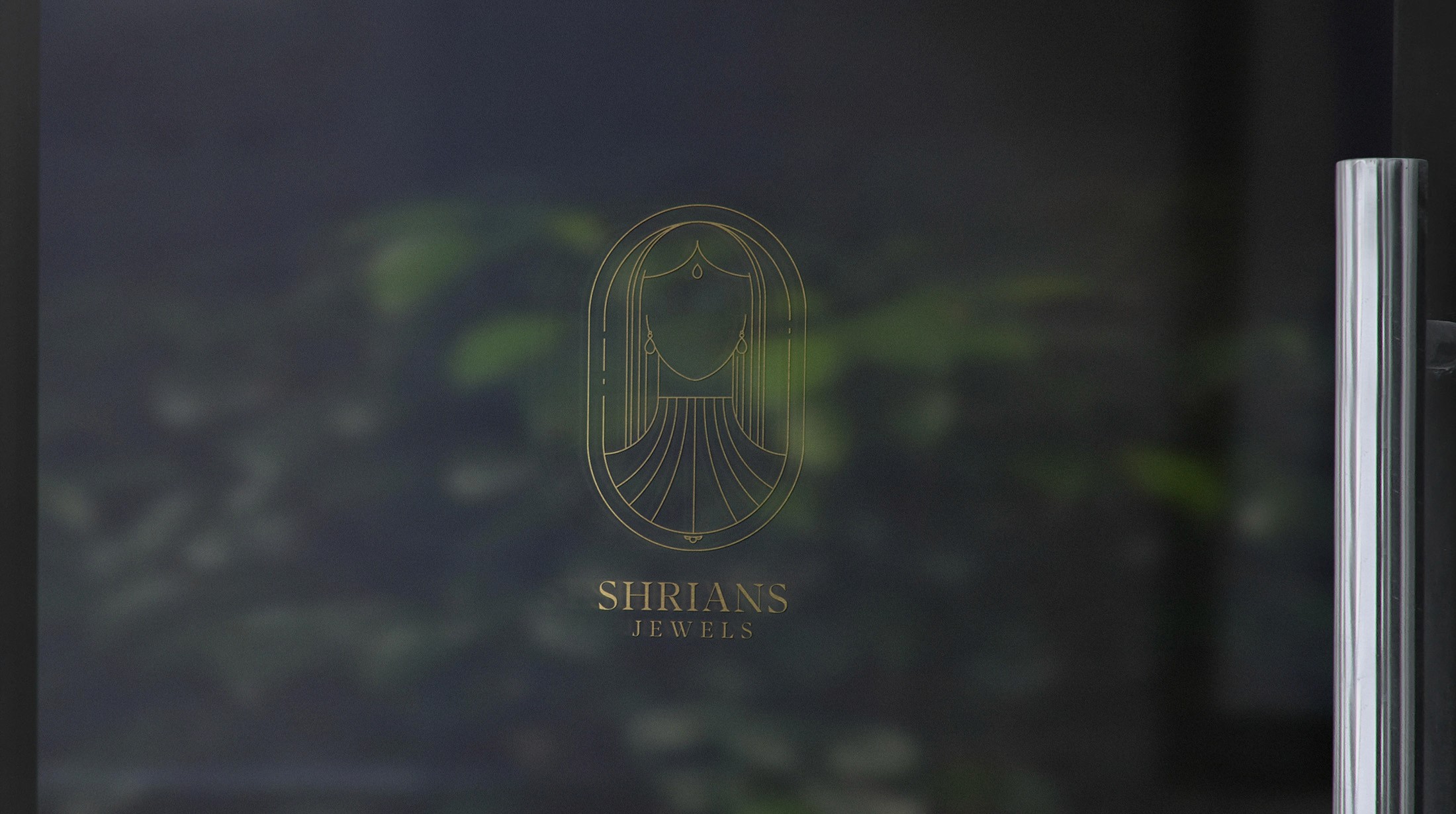 Shrians Jewels logo as a frosted decal on a glass shop window