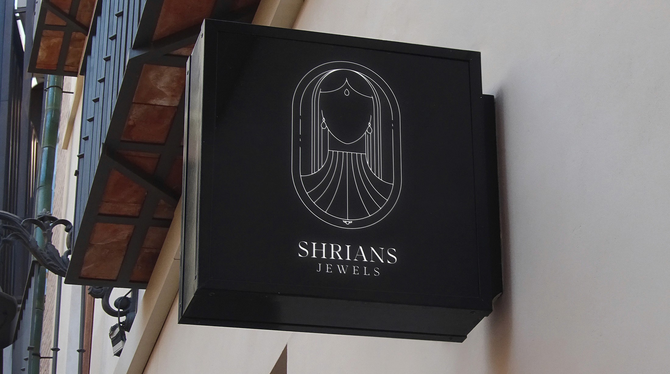 Shrians Jewels hanging sign on a heritage building facade