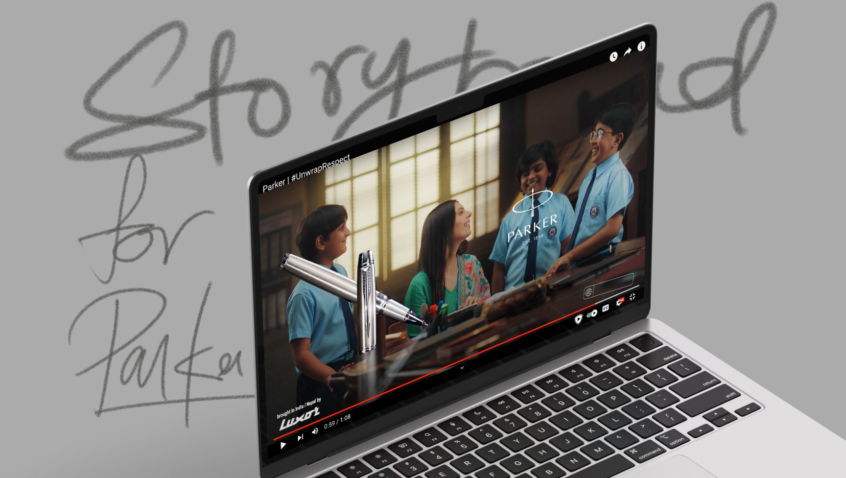Laptop playing a Parker Pens school-themed TV commercial beside the handwritten words Storyboard for Parker