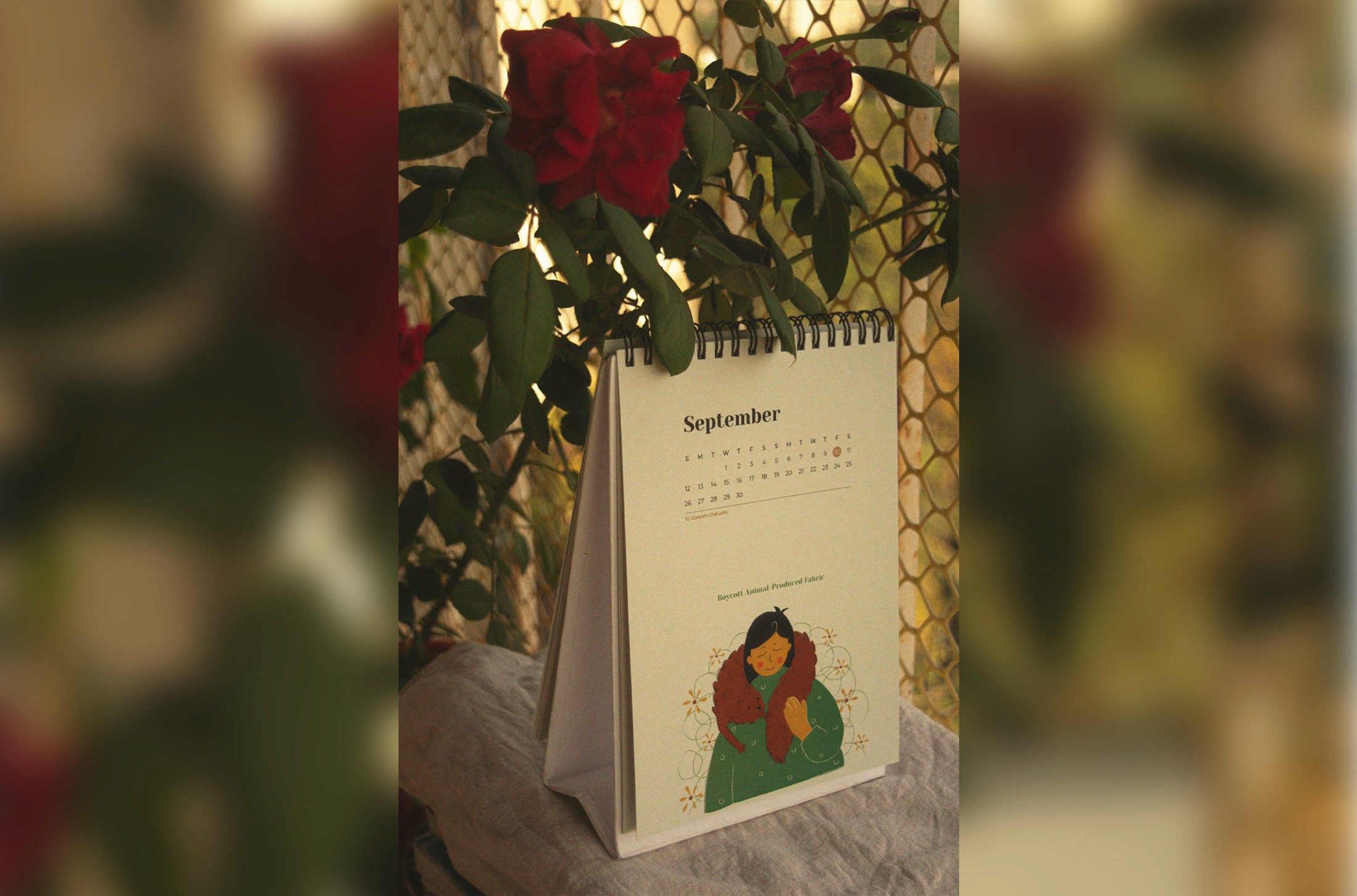 Year of the Planet desk calendar open to September among red roses